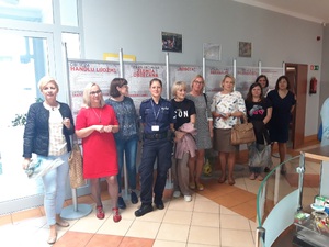 Na zdjęciu widać grupę osób pozujących do zdjęcia na korytarzu w budynku PCPR.